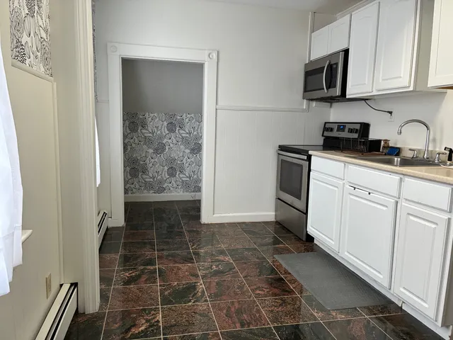 a kitchen with a sink and cabinets