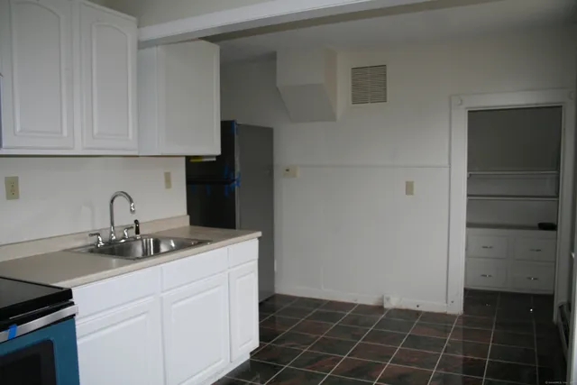 a kitchen with a sink and cabinets