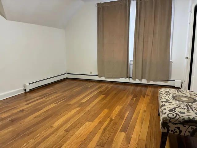 a view of a room with wooden floor