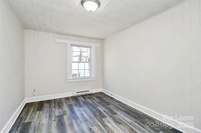 a view of a room with wooden floor and windows