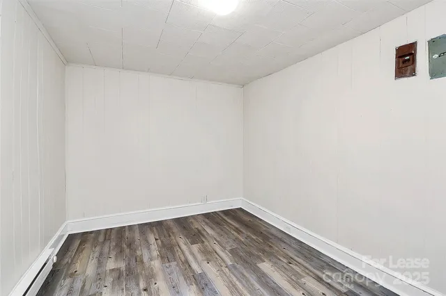 a view of a room with wooden floor