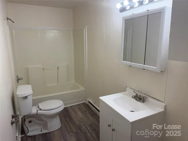 a bathroom with a toilet a sink and a mirror