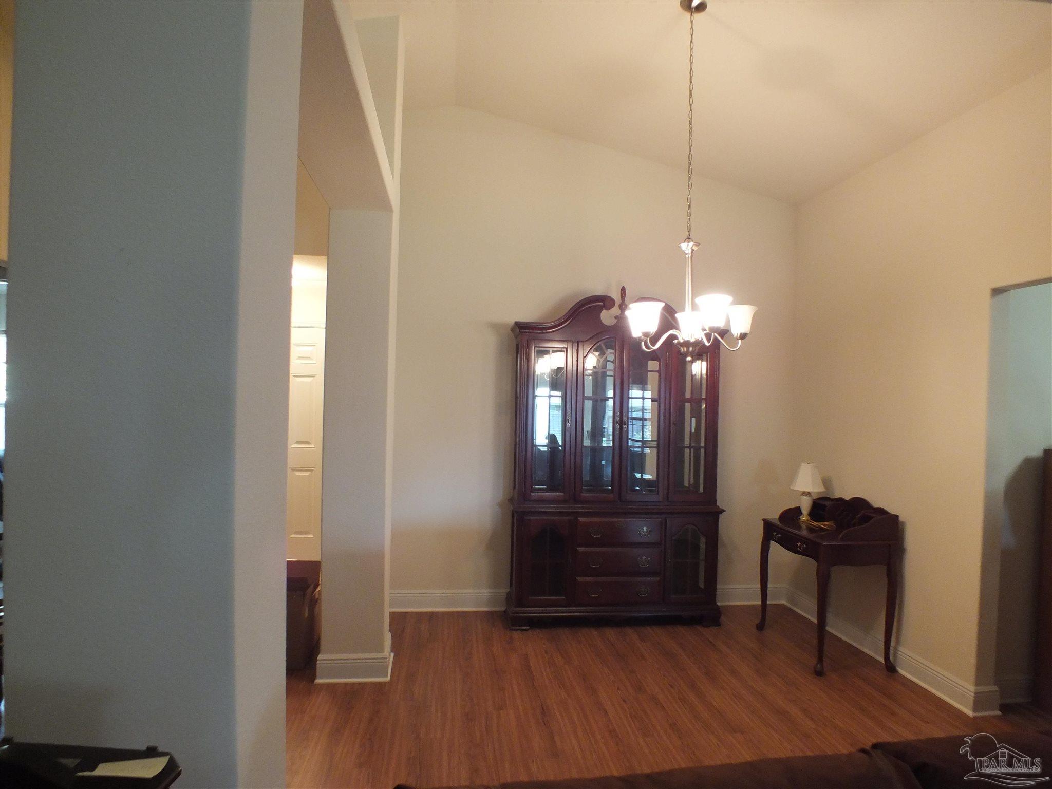 4441 Fiske Street Pace, FL 32571 - Photo 12 of 16 a view of a room with wooden floor