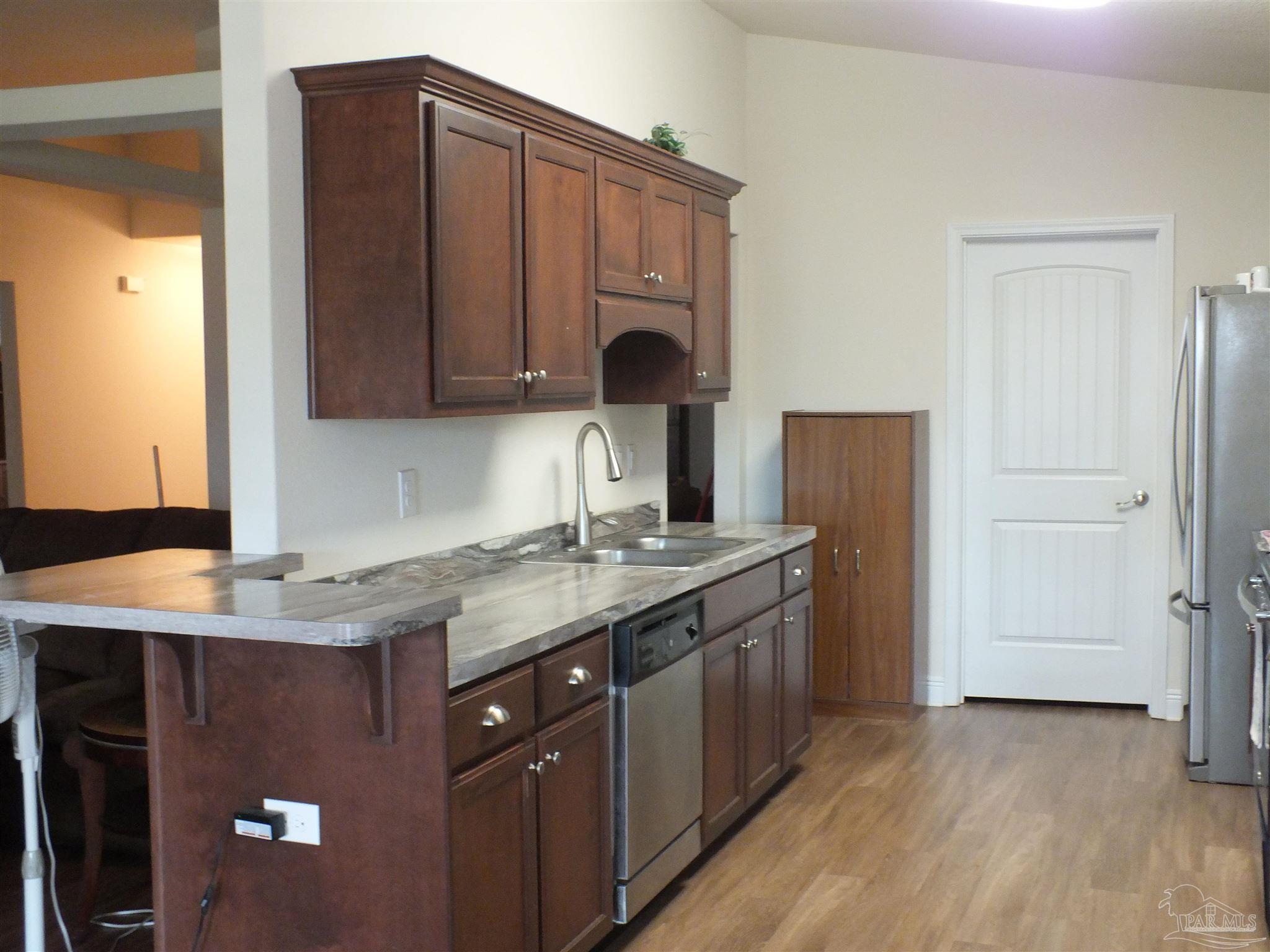 4441 Fiske Street Pace, FL 32571 - Photo 4 of 16 a kitchen with a sink and a cabinets