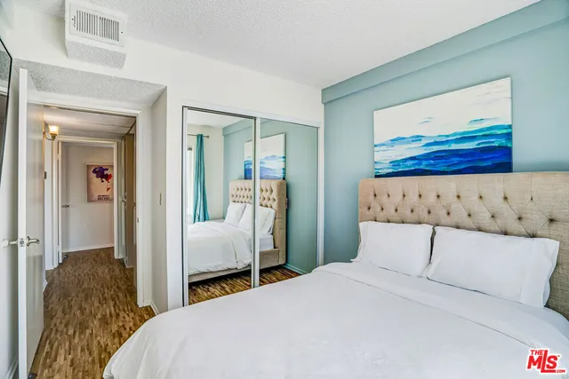 a bedroom with a bed and a mirror