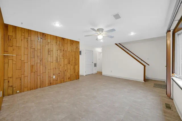 a view of an empty room with a chandelier