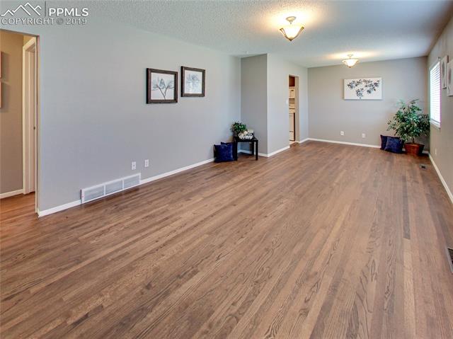 1904 North Chelton Road Colorado Springs, CO 80909 - Photo 4 of 31 Living Room looking to Breakfast Room