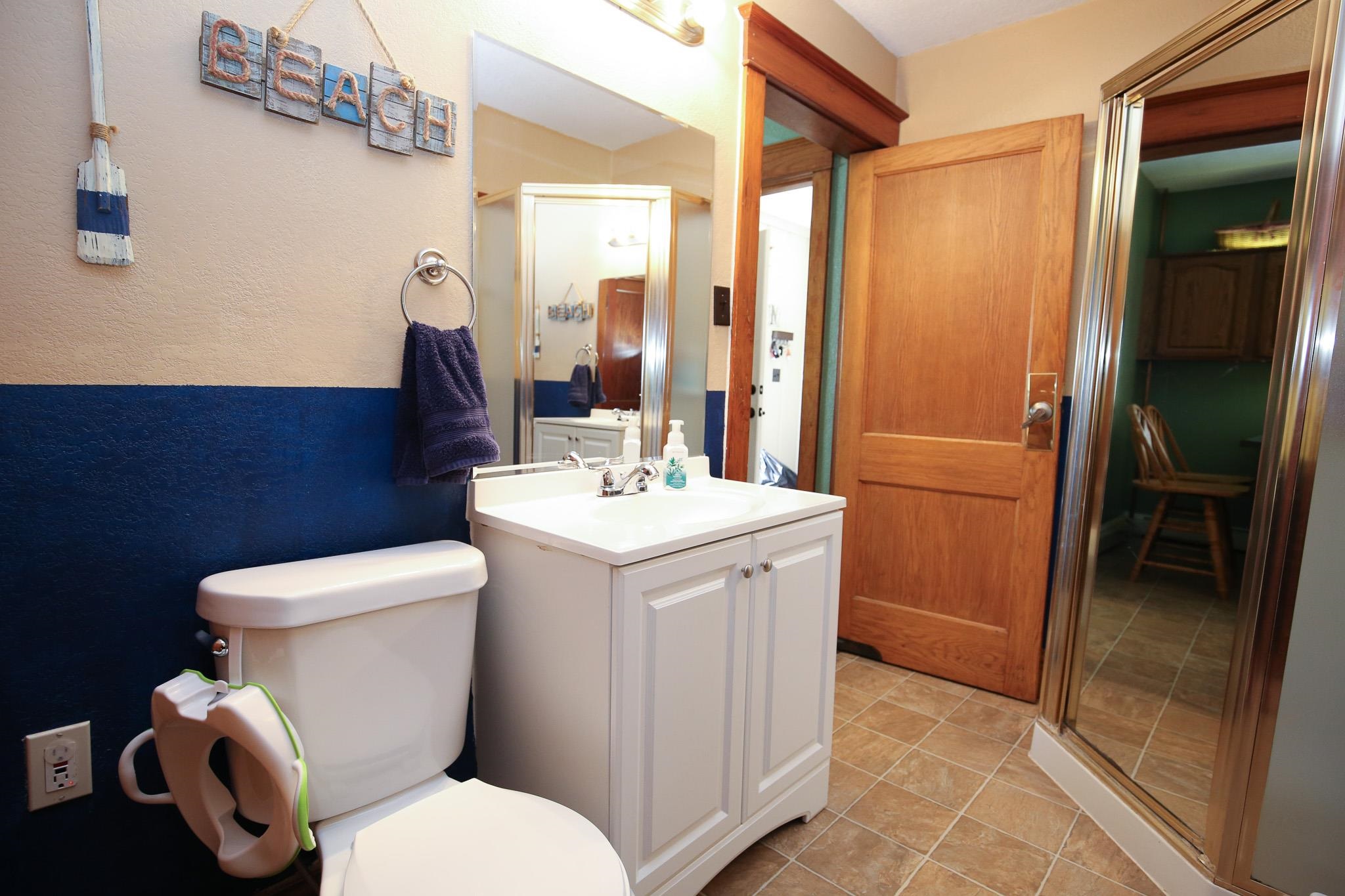 1905 Melugins Grove Road Rochelle, IL 61068 - Photo 16 of 36 a bathroom with a toilet sink and mirror