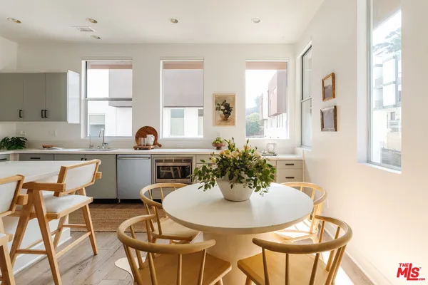 a kitchen with a dining table and chairs