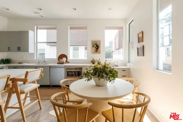 a kitchen with a dining table and chairs