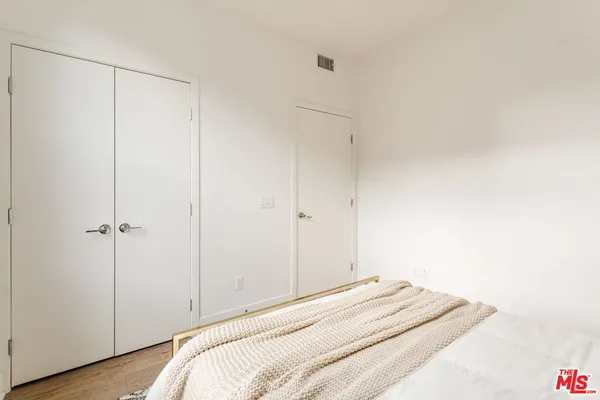 a bedroom with a bed and a closet