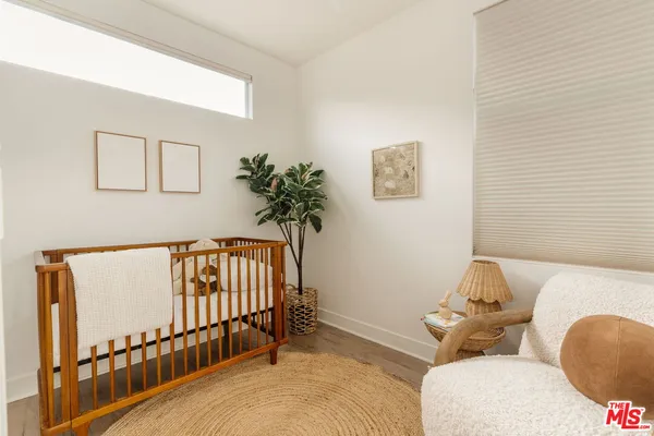 a bedroom with furniture and a window
