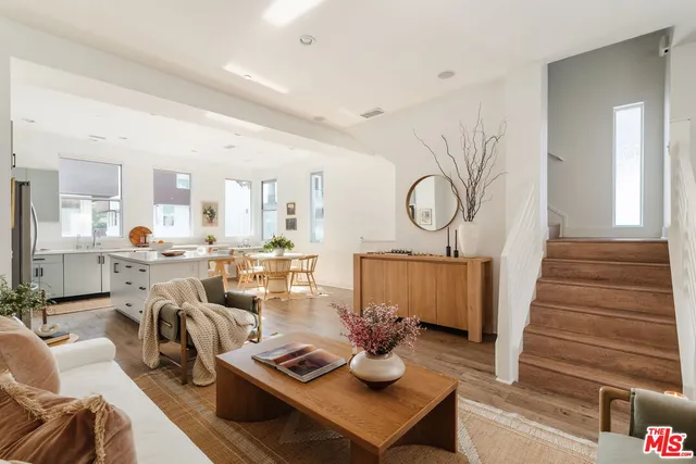 a living room with furniture a rug and white walls