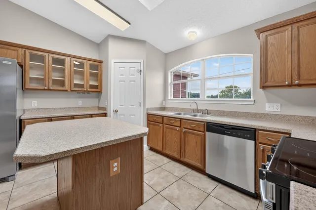 a kitchen that has a cabinets a sink and a stove