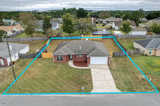 an aerial view of residential houses with outdoor space