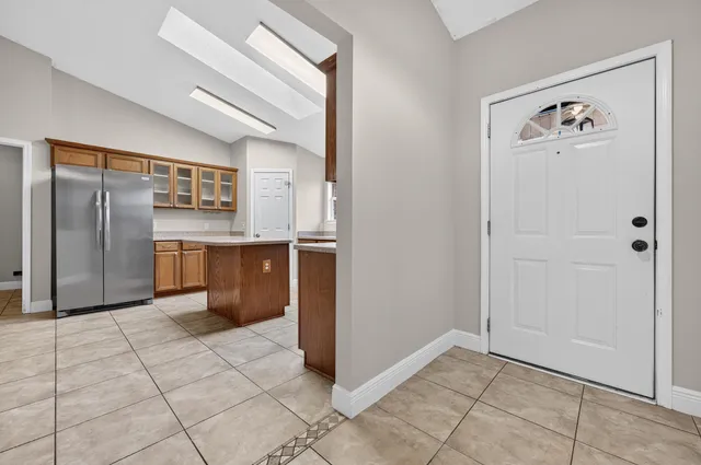 a view of an empty room with a ceiling fan and window