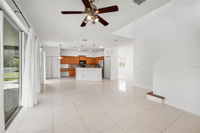 a view of a kitchen with a sink and a refrigerator cabinets