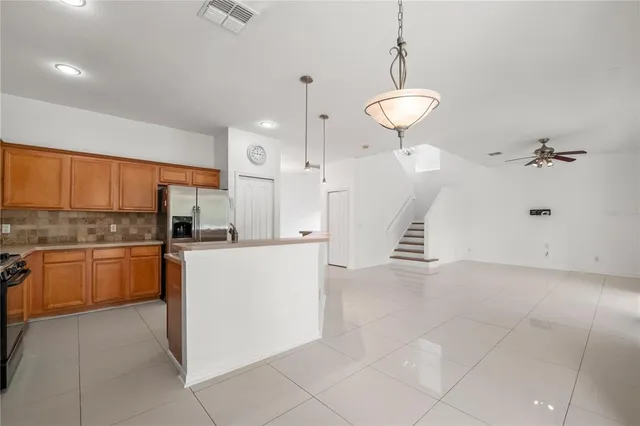a view of a kitchen with furniture and a ceiling fan