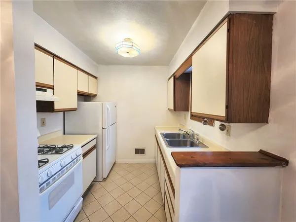 a kitchen with a sink stove and refrigerator