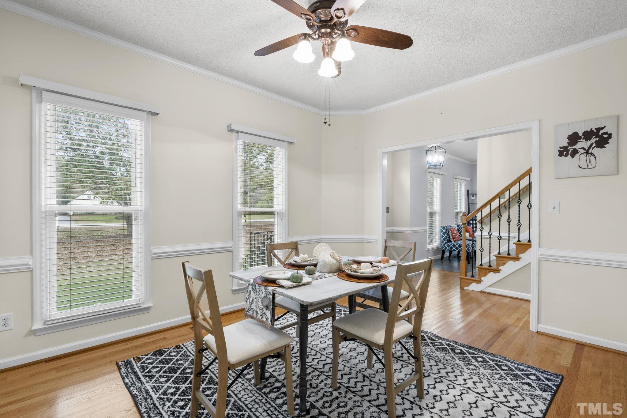 1101 Sky Point Court Raleigh, NC 27603 - Photo 11 of 52 a dining room with furniture a chandelier and wooden floor