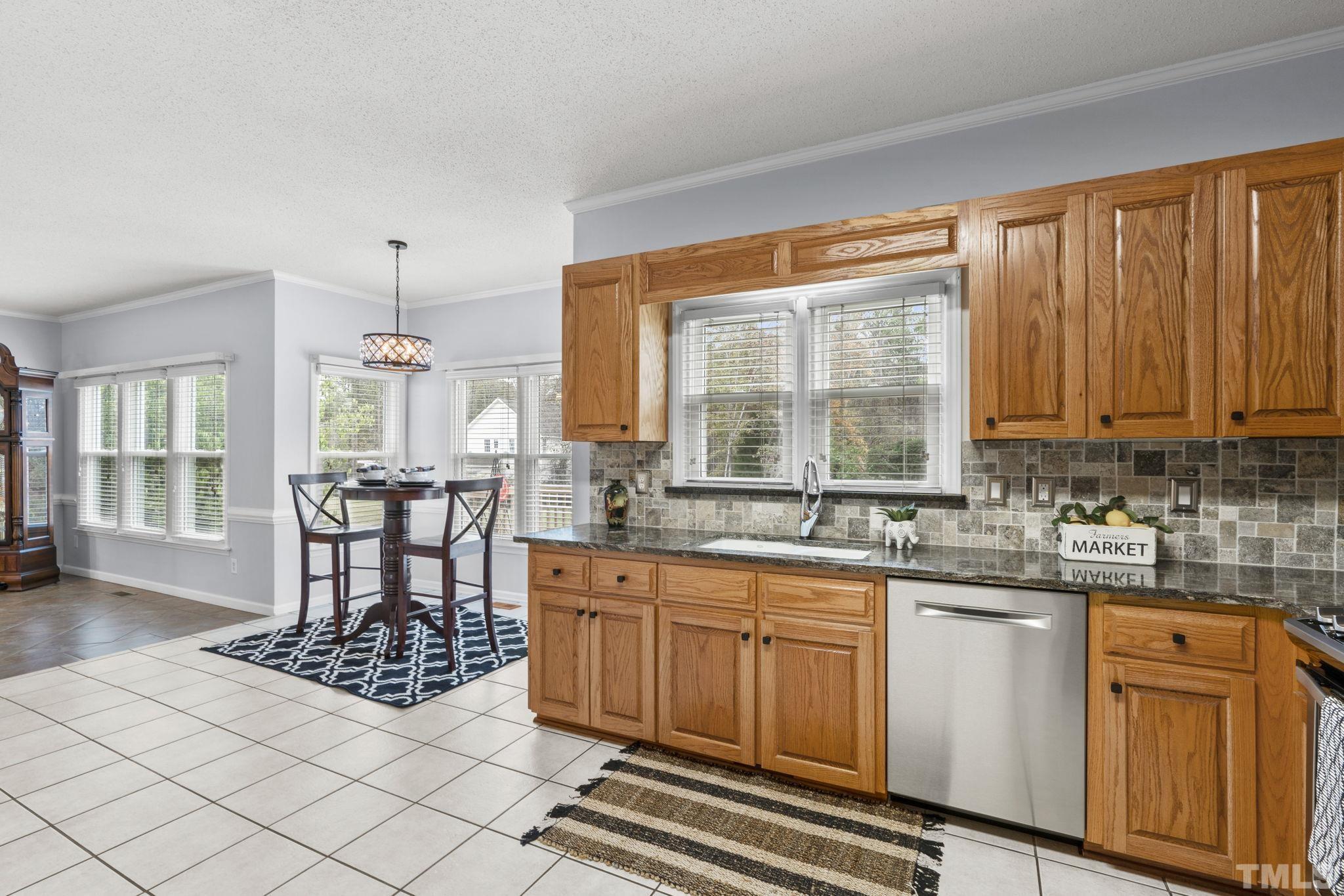 1101 Sky Point Court Raleigh, NC 27603 - Photo 15 of 52 a kitchen with a stove a sink and cabinets