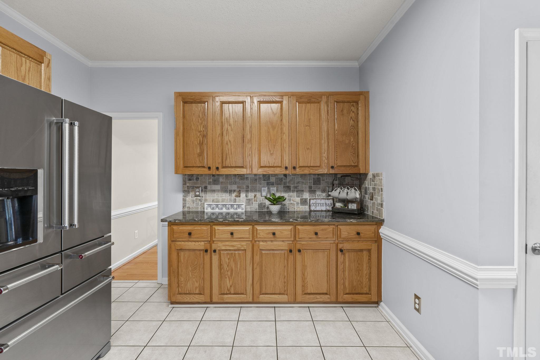 1101 Sky Point Court Raleigh, NC 27603 - Photo 16 of 52 a kitchen with granite countertop a stove a sink and a refrigerator