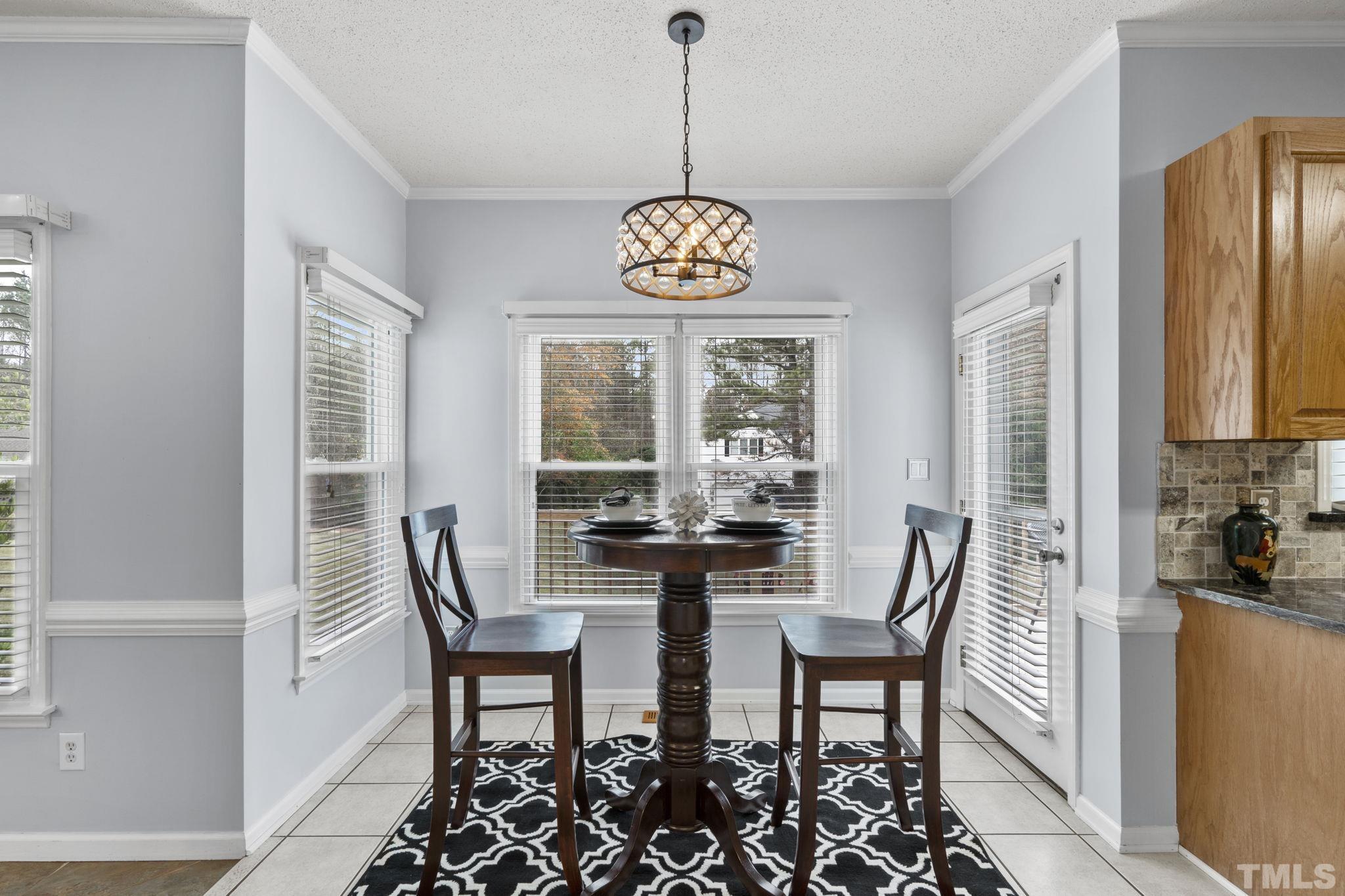 1101 Sky Point Court Raleigh, NC 27603 - Photo 18 of 52 a view of a dining room with furniture window and outside view