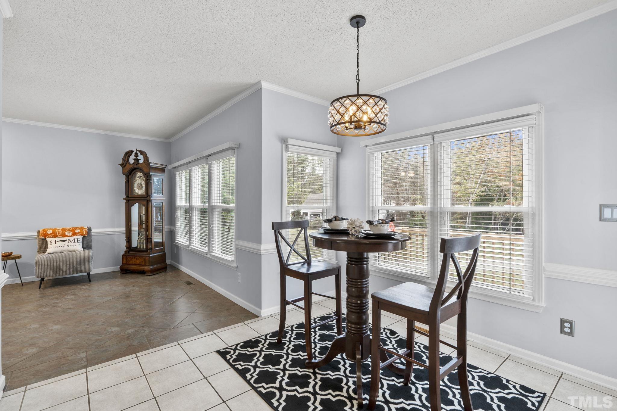 1101 Sky Point Court Raleigh, NC 27603 - Photo 19 of 52 a view of a dining room and livingroom with furniture wooden floor and a chandelier