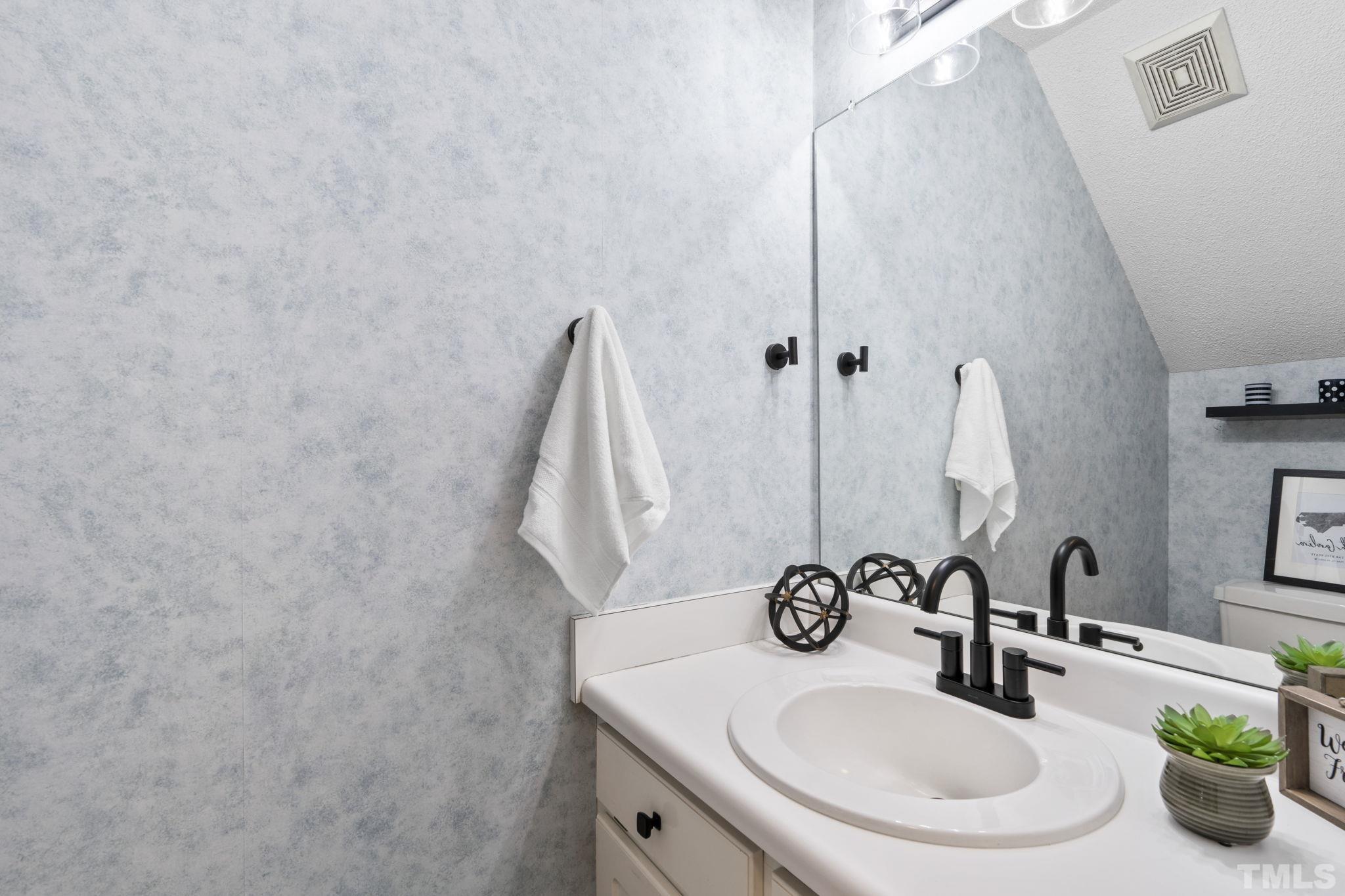1101 Sky Point Court Raleigh, NC 27603 - Photo 20 of 52 a bathroom with a sink and a mirror