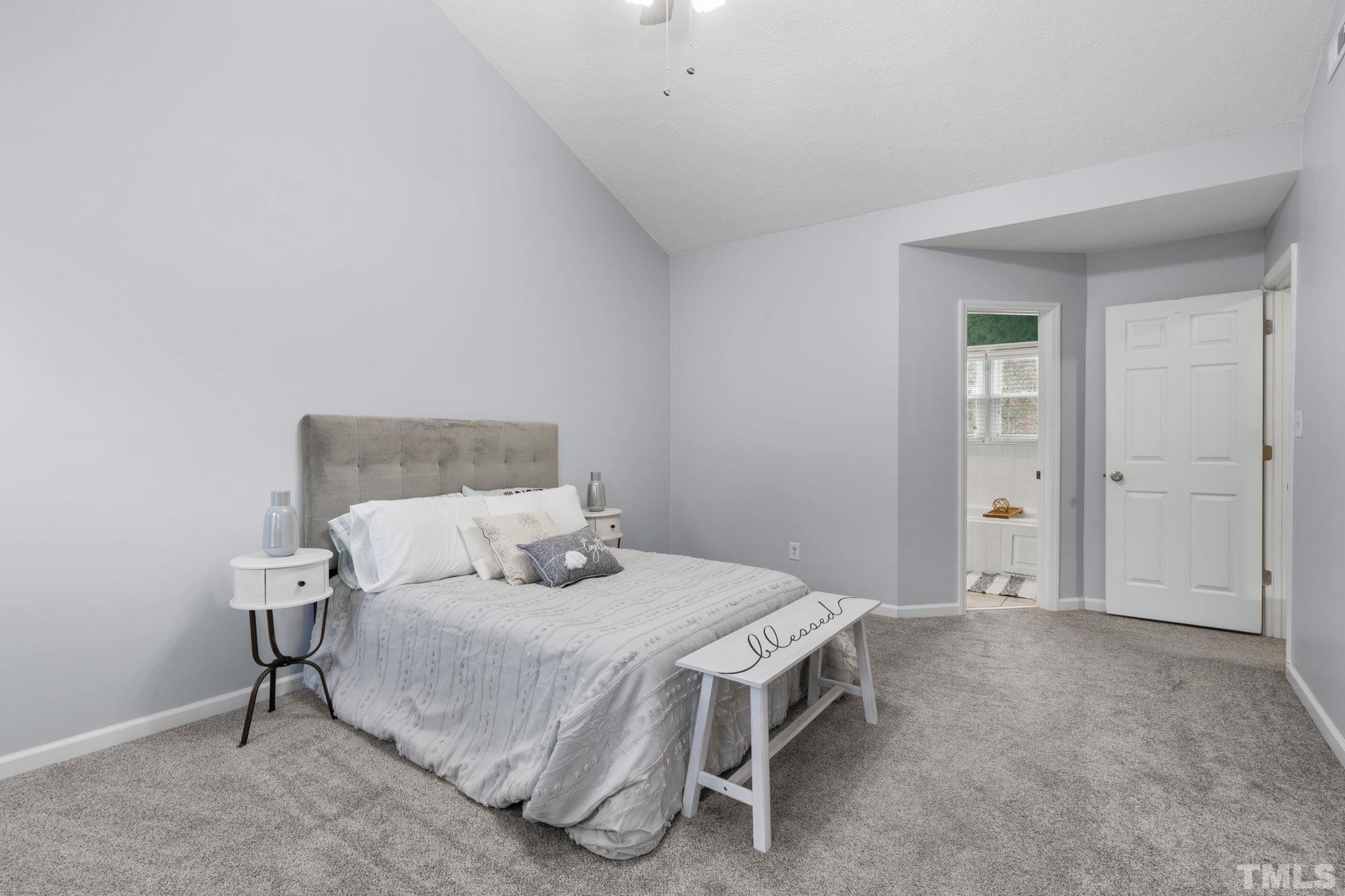 1101 Sky Point Court Raleigh, NC 27603 - Photo 24 of 52 a bed room with a bed and a night stand