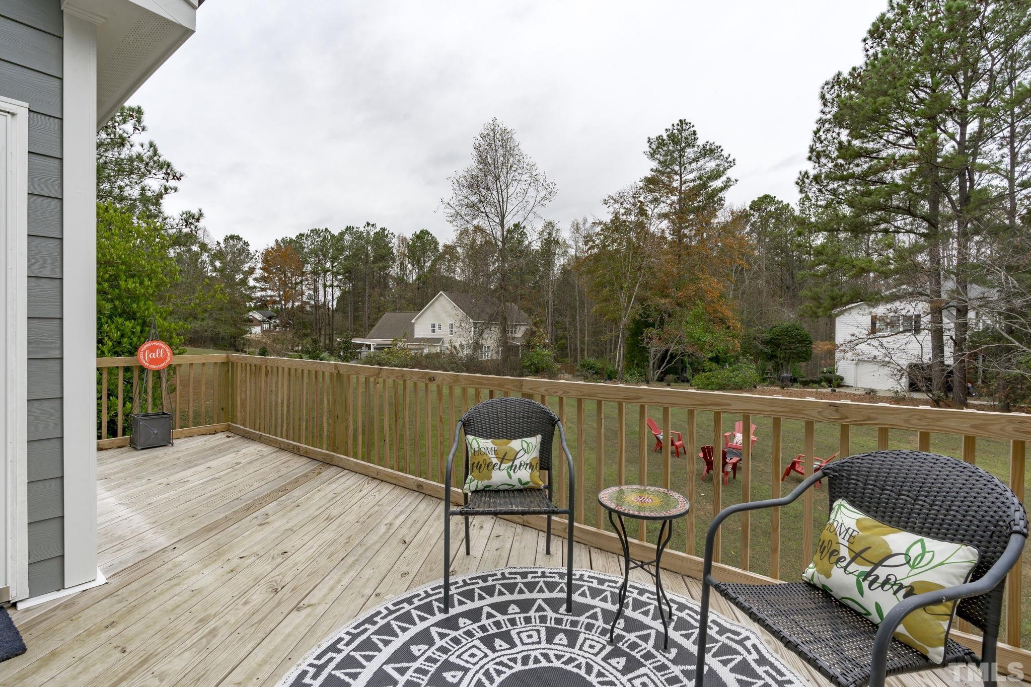 1101 Sky Point Court Raleigh, NC 27603 - Photo 35 of 52 a balcony with wooden floor table and chairs