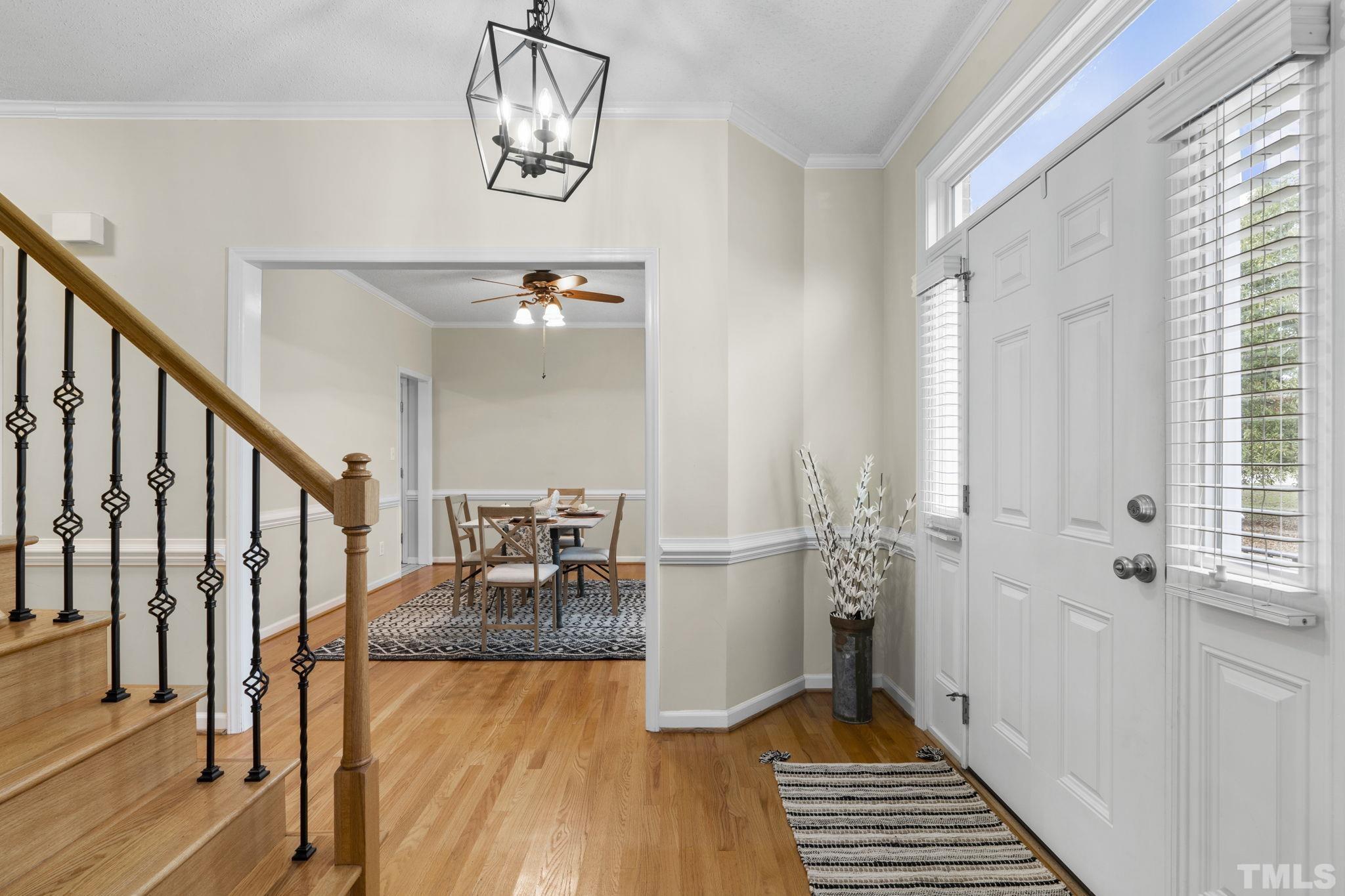 1101 Sky Point Court Raleigh, NC 27603 - Photo 4 of 52 a view of a hallway with wooden floor and staircase