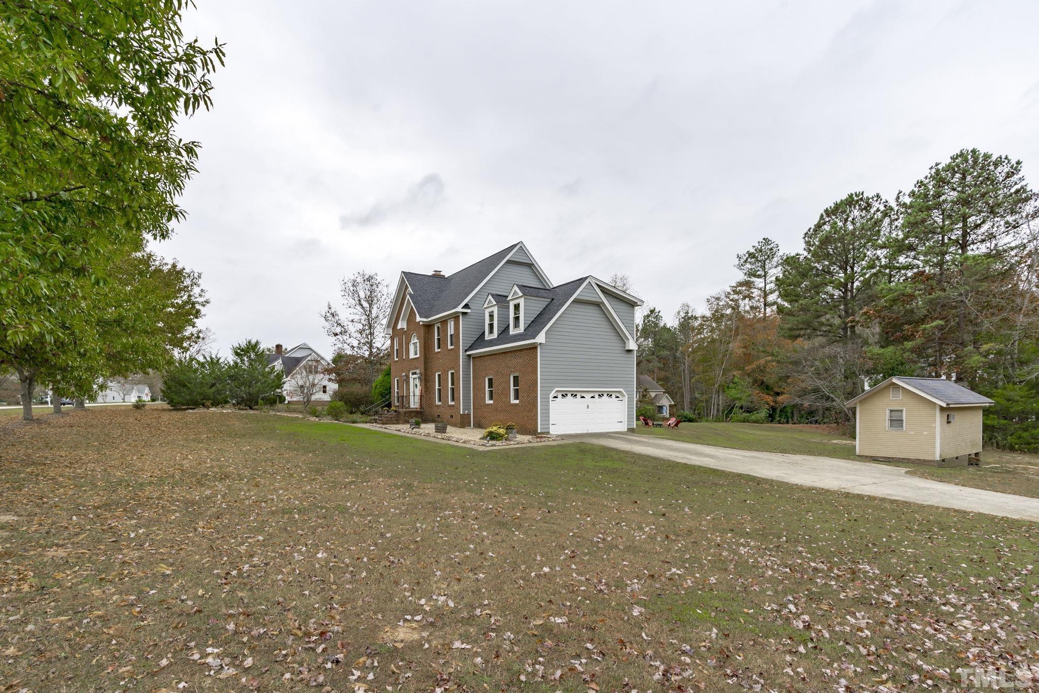1101 Sky Point Court Raleigh, NC 27603 - Photo 49 of 52 a house with trees in front of it