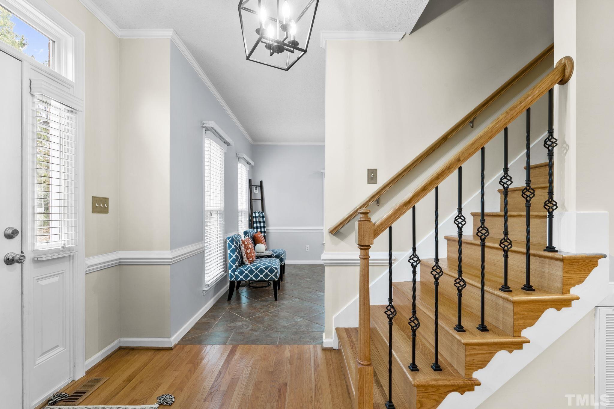 1101 Sky Point Court Raleigh, NC 27603 - Photo 5 of 52 a view of entryway with wooden floor and stairs