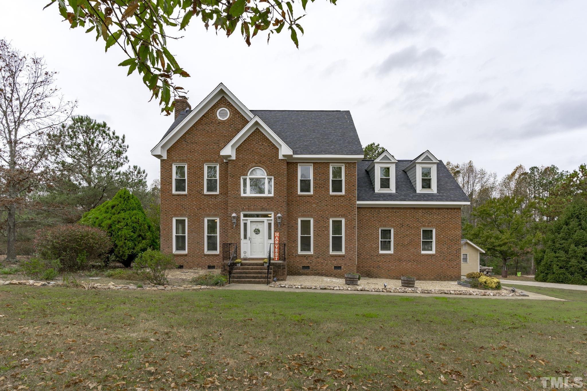 1101 Sky Point Court Raleigh, NC 27603 - Photo 51 of 52 a front view of a house with a garden