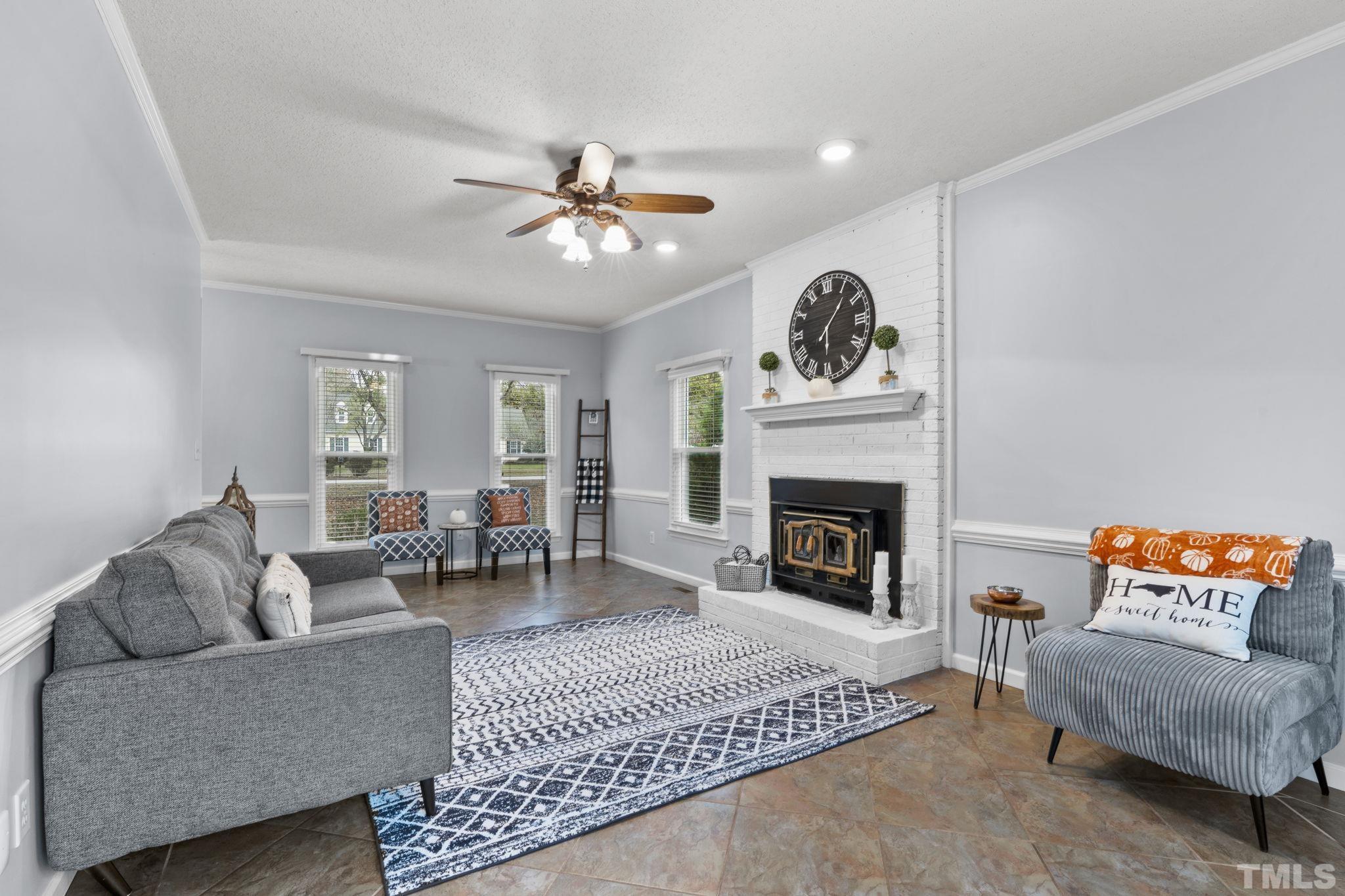 1101 Sky Point Court Raleigh, NC 27603 - Photo 9 of 52 a living room with furniture and a fireplace