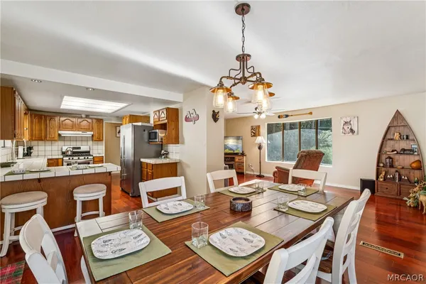 a living room with furniture a rug and a chandelier