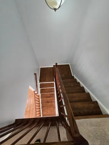 a view of staircase with wooden floor