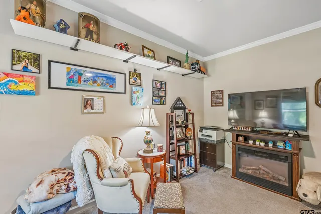 a living room with furniture a flat screen tv and a floor to ceiling window