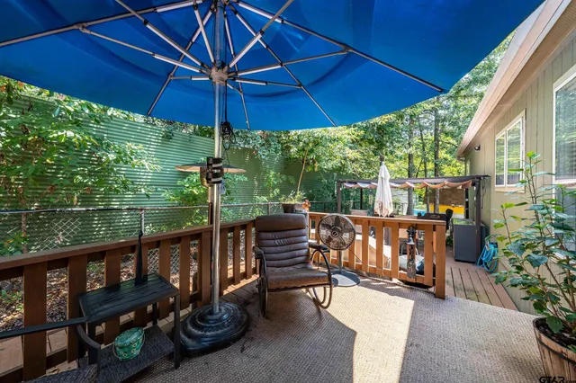 a view of a roof deck with a table and chairs under an umbrella