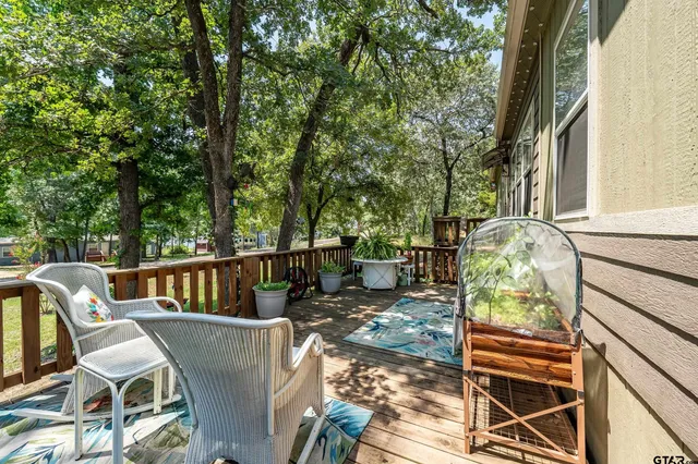 a view of a patio with table and chairs and wooden floor