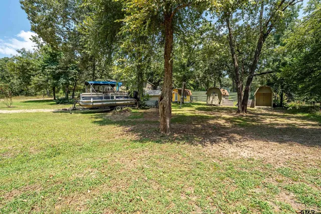 a view of a yard with swimming pool