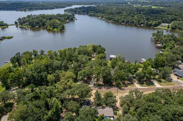 an aerial view of residential house with outdoor space and lake view