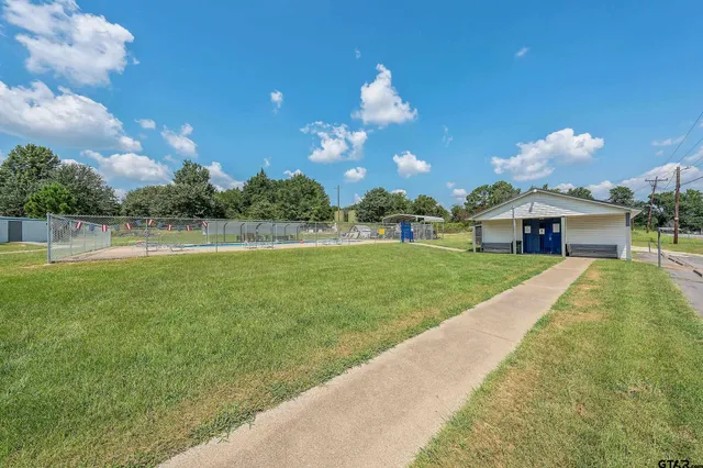 a view of a house with a yard and a patio