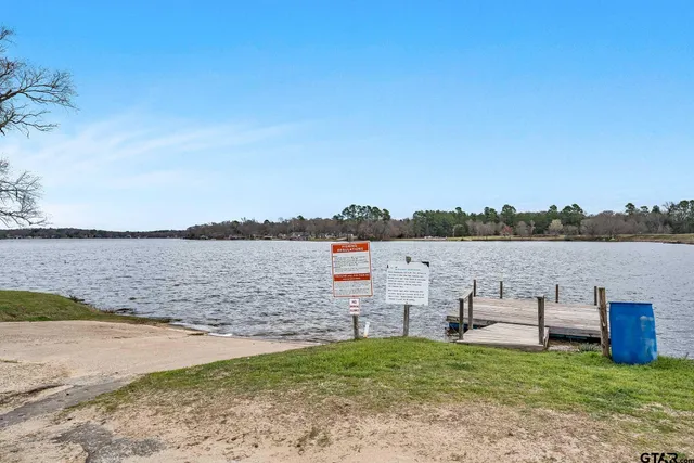 a view of a lake with table and chairs