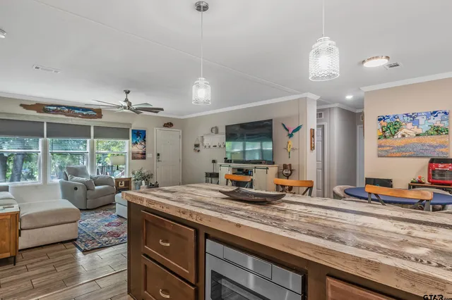 a living room with furniture a flat screen tv and a large window