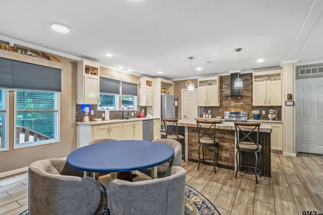a kitchen with a table and chairs in it