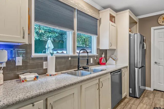 a kitchen with a sink and a large window