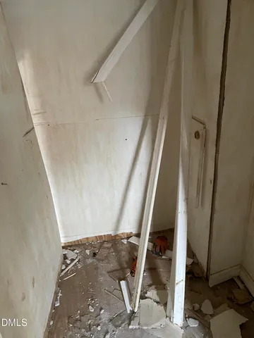a view of a livingroom with wooden floor and a window