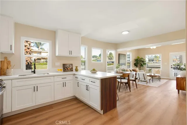 a kitchen with a sink and wooden floor